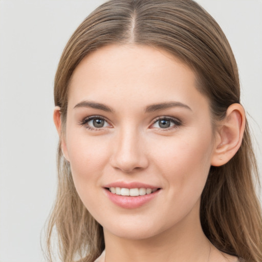 Joyful white young-adult female with long  brown hair and grey eyes