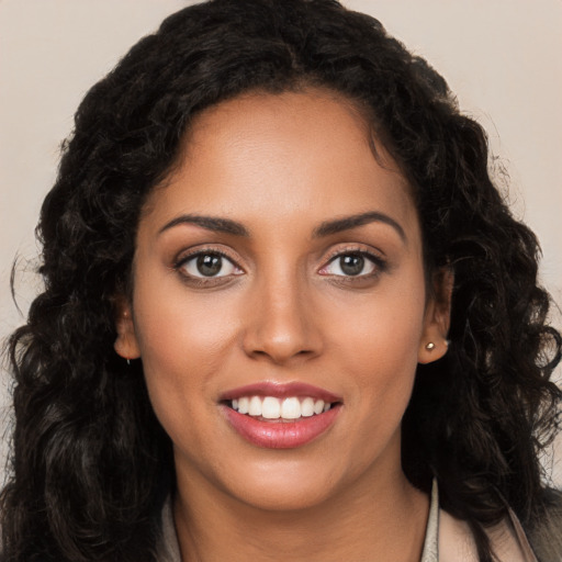 Joyful latino young-adult female with long  brown hair and brown eyes