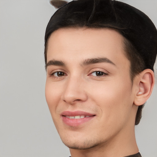 Joyful white young-adult male with short  black hair and brown eyes