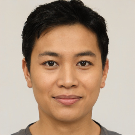 Joyful asian young-adult male with short  black hair and brown eyes