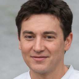 Joyful white adult male with short  brown hair and brown eyes