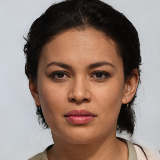 Joyful latino young-adult female with medium  brown hair and brown eyes