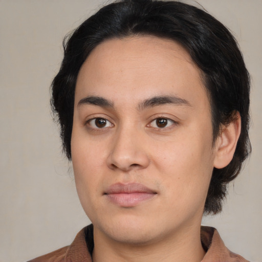 Joyful white young-adult male with medium  black hair and brown eyes