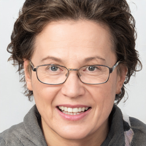 Joyful white adult female with medium  brown hair and blue eyes