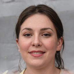 Joyful white young-adult female with medium  brown hair and grey eyes