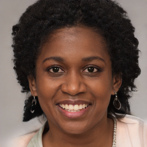 Joyful black young-adult female with medium  brown hair and brown eyes