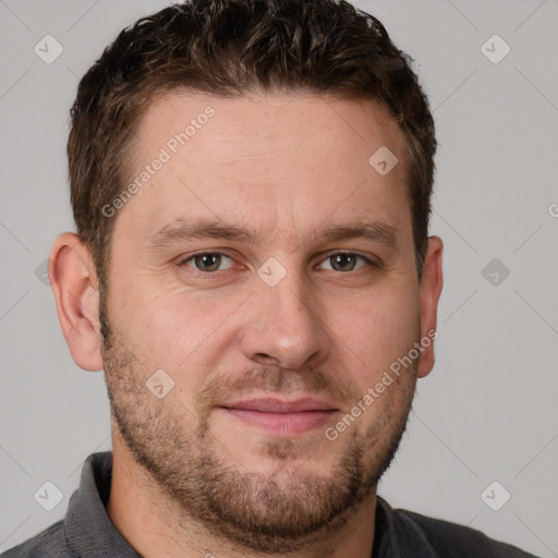 Joyful white adult male with short  brown hair and brown eyes