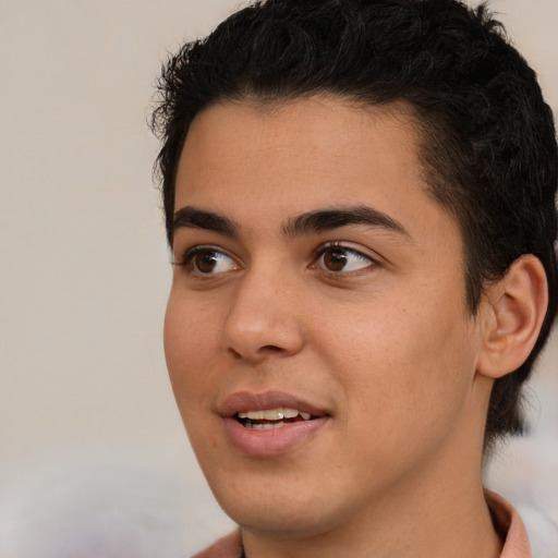 Joyful latino young-adult male with short  brown hair and brown eyes