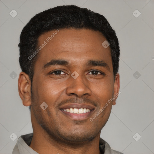 Joyful black young-adult male with short  black hair and brown eyes