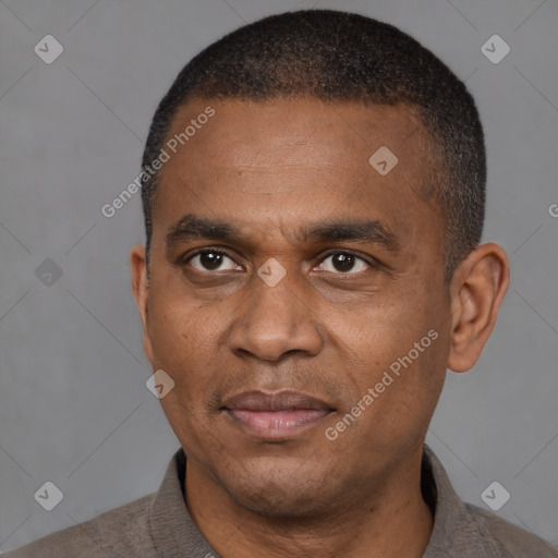 Joyful latino adult male with short  brown hair and brown eyes