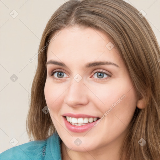 Joyful white young-adult female with long  brown hair and green eyes