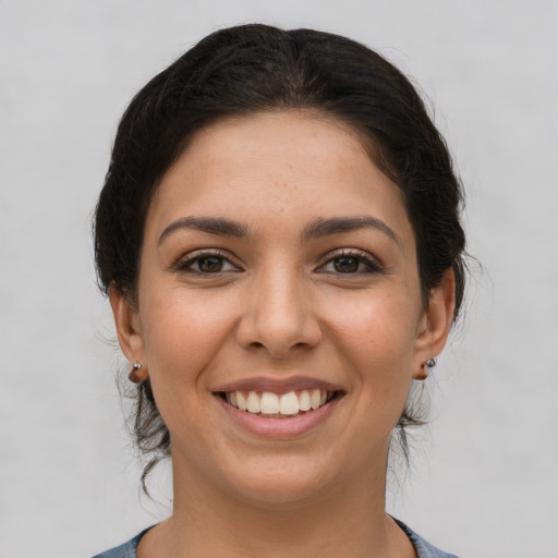 Joyful latino young-adult female with short  brown hair and brown eyes