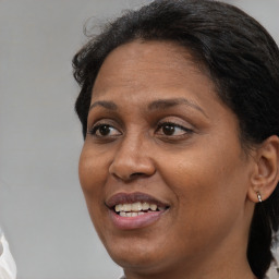 Joyful black adult female with short  brown hair and brown eyes