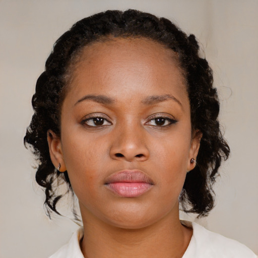 Neutral black young-adult female with medium  brown hair and brown eyes