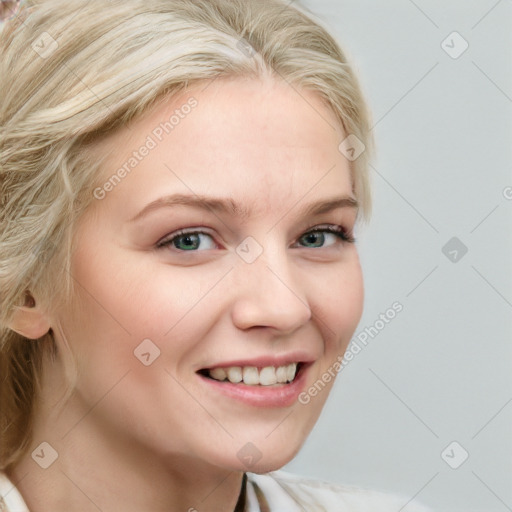 Joyful white young-adult female with long  blond hair and blue eyes