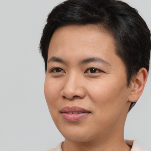 Joyful asian young-adult female with short  brown hair and brown eyes