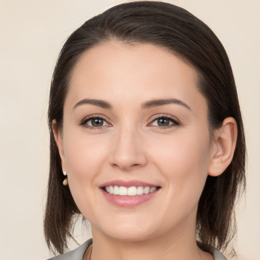 Joyful white young-adult female with medium  brown hair and brown eyes