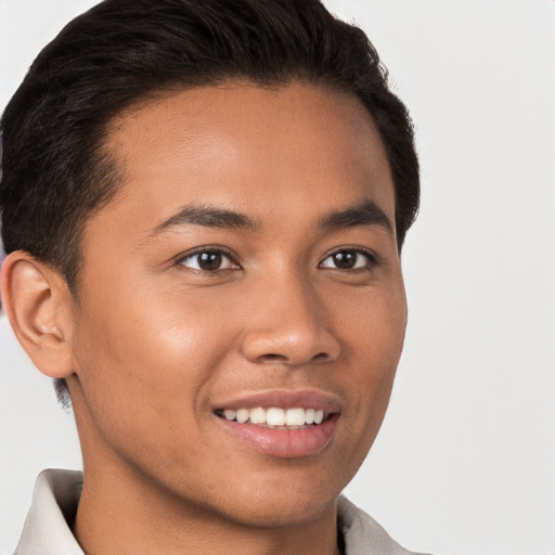 Joyful latino young-adult male with short  brown hair and brown eyes