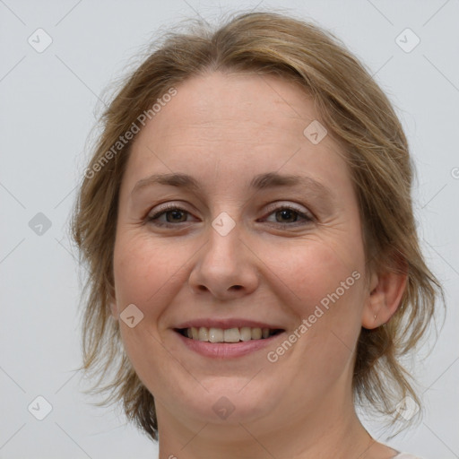 Joyful white young-adult female with medium  brown hair and blue eyes