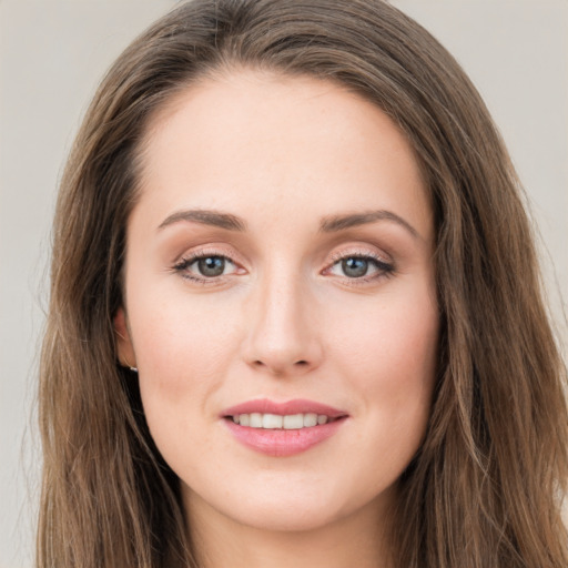 Joyful white young-adult female with long  brown hair and grey eyes