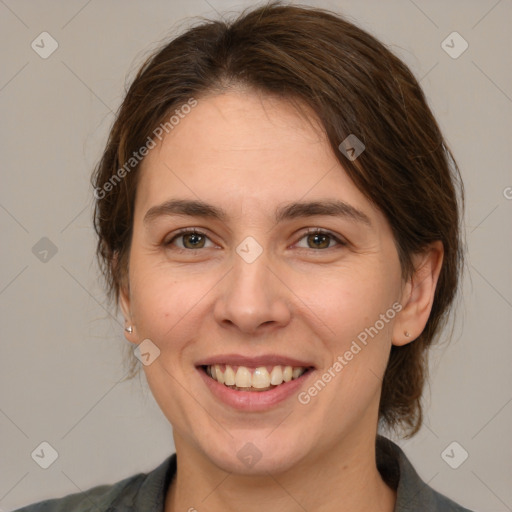 Joyful white young-adult female with medium  brown hair and grey eyes