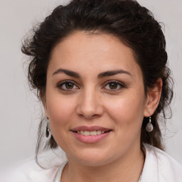 Joyful white young-adult female with medium  brown hair and brown eyes