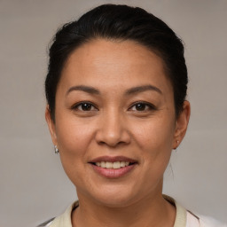 Joyful white adult female with short  brown hair and brown eyes