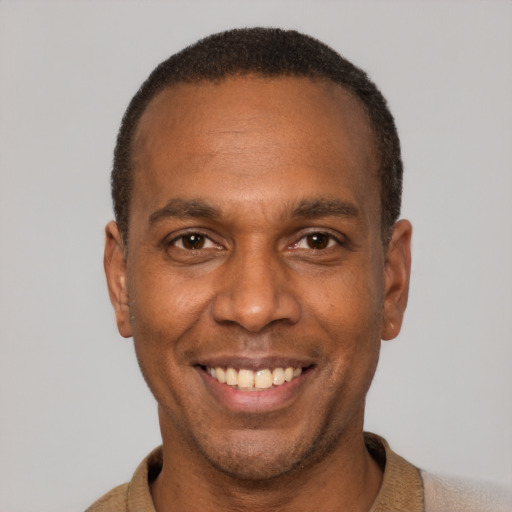 Joyful latino adult male with short  brown hair and brown eyes