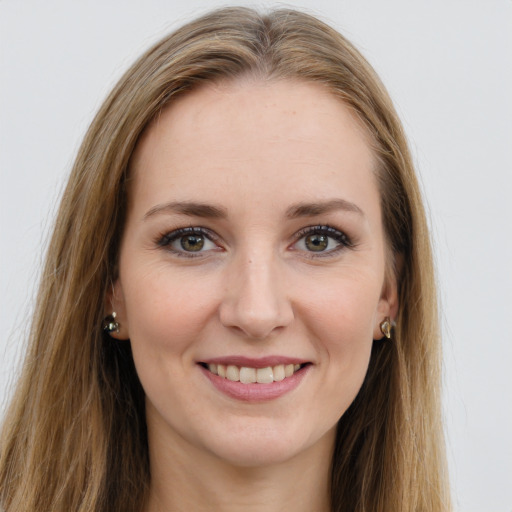 Joyful white young-adult female with long  brown hair and green eyes