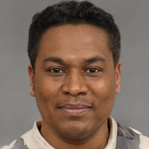 Joyful latino adult male with short  brown hair and brown eyes