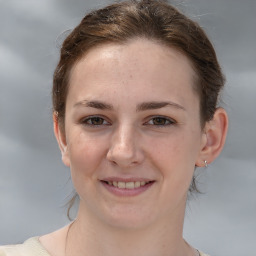 Joyful white young-adult female with medium  brown hair and grey eyes