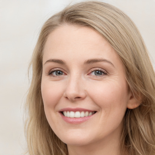 Joyful white young-adult female with long  brown hair and green eyes