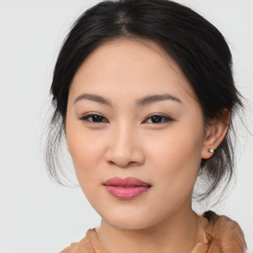Joyful asian young-adult female with medium  brown hair and brown eyes