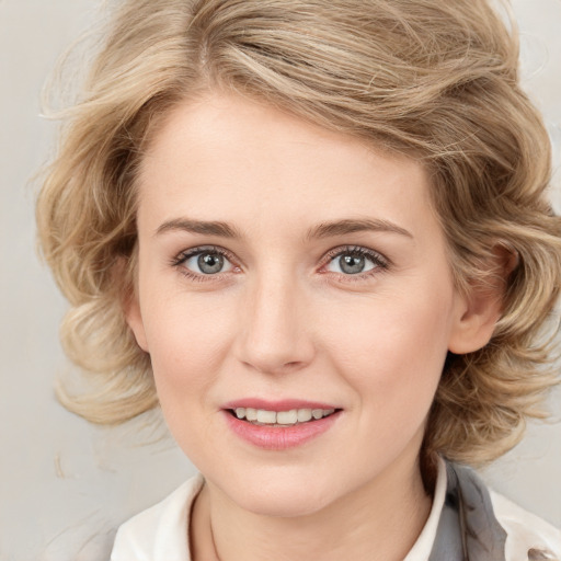 Joyful white young-adult female with medium  brown hair and blue eyes