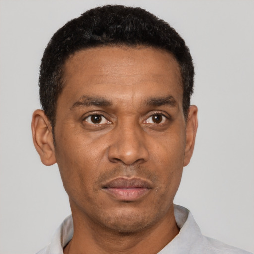 Joyful latino adult male with short  black hair and brown eyes