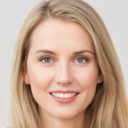 Joyful white young-adult female with long  brown hair and blue eyes