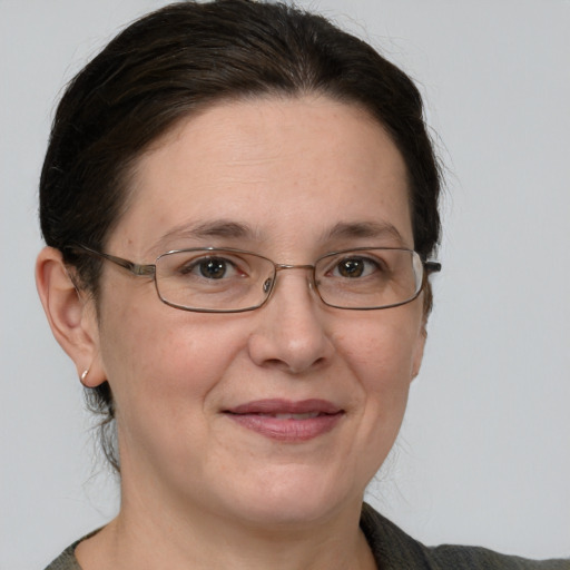 Joyful white adult female with short  brown hair and grey eyes