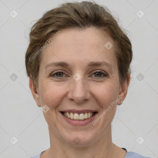 Joyful white adult female with short  brown hair and grey eyes