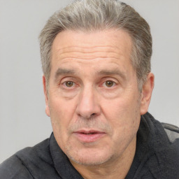 Joyful white middle-aged male with short  brown hair and brown eyes