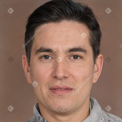 Joyful white adult male with short  black hair and brown eyes