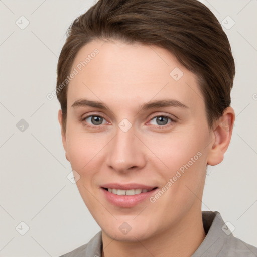 Joyful white young-adult female with short  brown hair and grey eyes