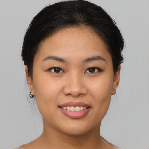 Joyful asian young-adult female with short  brown hair and brown eyes