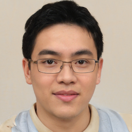 Joyful asian young-adult male with short  brown hair and brown eyes