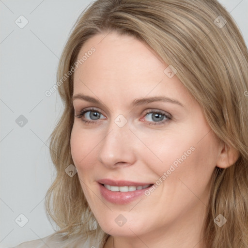 Joyful white young-adult female with long  brown hair and blue eyes