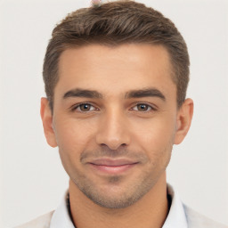 Joyful white young-adult male with short  brown hair and brown eyes