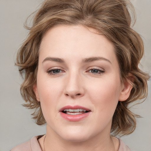 Joyful white young-adult female with medium  brown hair and blue eyes