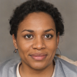 Joyful black adult female with short  brown hair and brown eyes