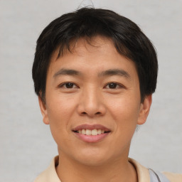 Joyful asian young-adult male with short  brown hair and brown eyes