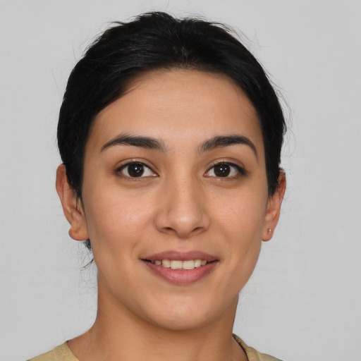 Joyful latino young-adult female with short  brown hair and brown eyes