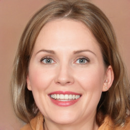 Joyful white young-adult female with medium  brown hair and blue eyes